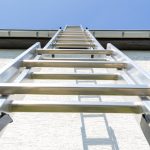 Extension Ladder resting on the Exterior of a Home. Matthews Painting Company offers safety tips on Extension Ladder Safety.