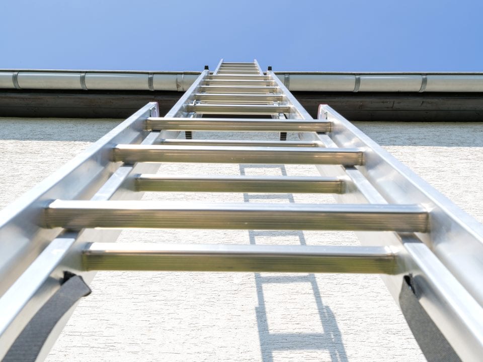 Extension Ladder resting on the Exterior of a Home. Matthews Painting Company offers safety tips on Extension Ladder Safety.