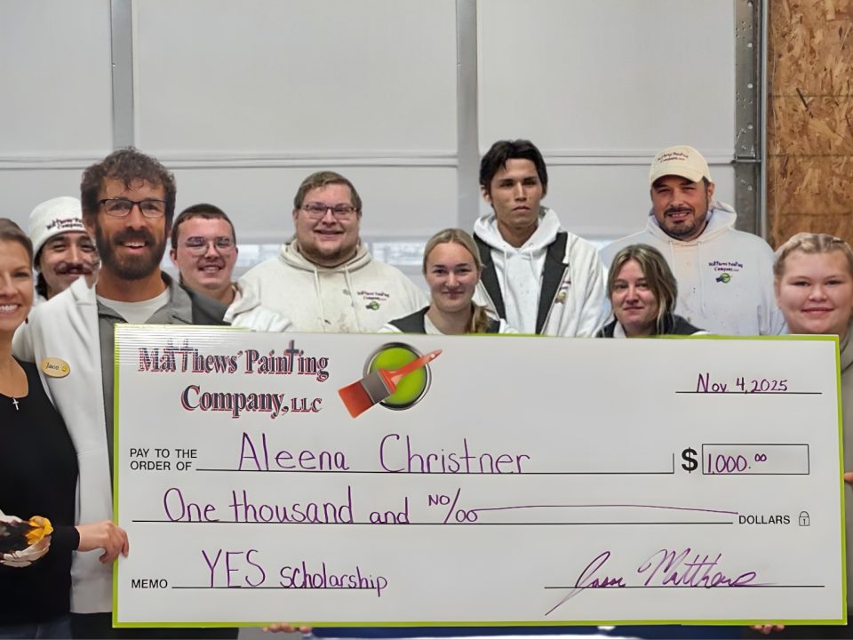 Matthews' Painting Company staff awards the 2025 Young Entrepreneur Scholarship Winner.
