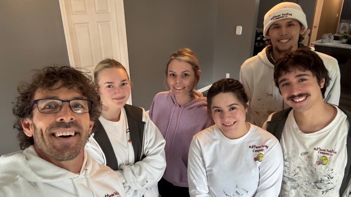 Matthews' Painting crew members with Paint It Forward recipient Kendall Rogers in Warsaw, Ind.
