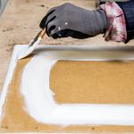 Repainting kitchen cabinet doors with white chalk paint indoors at home