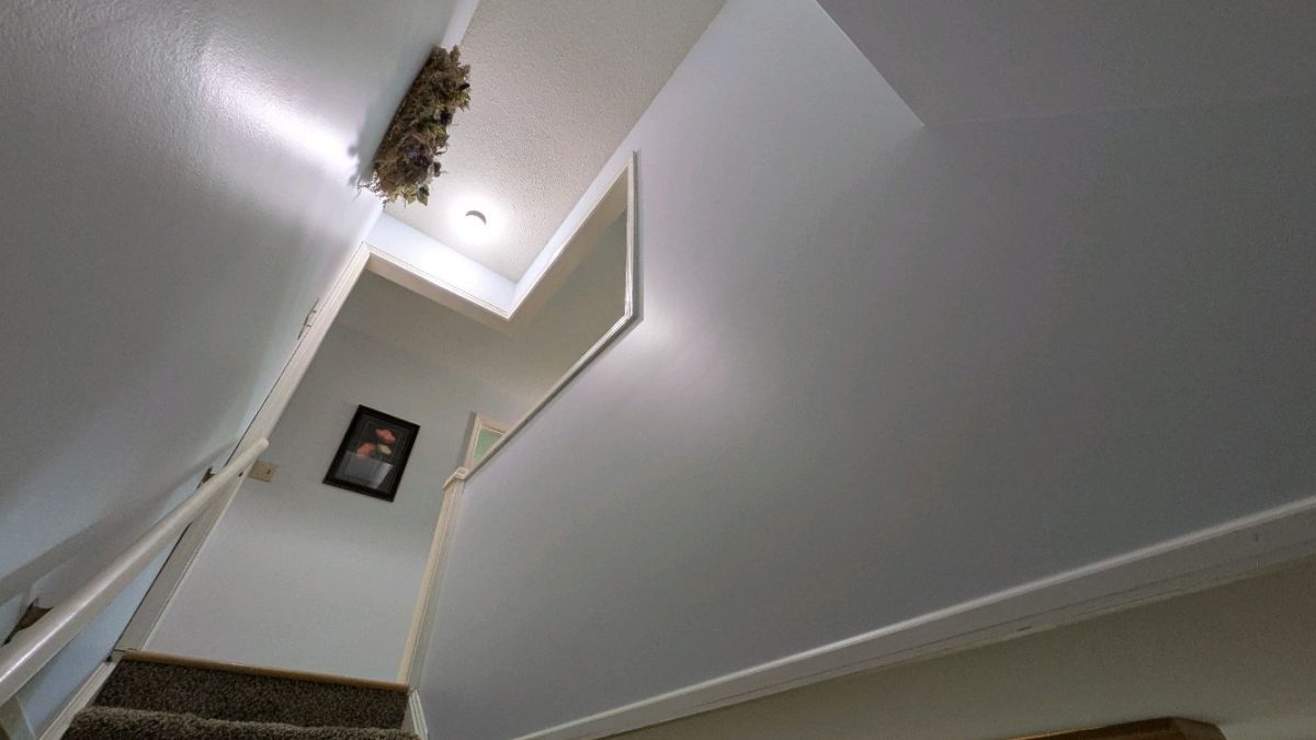 Before and after wallpaper removal and interior painting on a stairwell in Rochester, Indiana