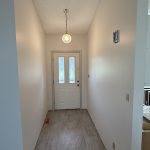 Freshly painted hallway with light neutral walls and white doors in an Albion, Indiana, home.